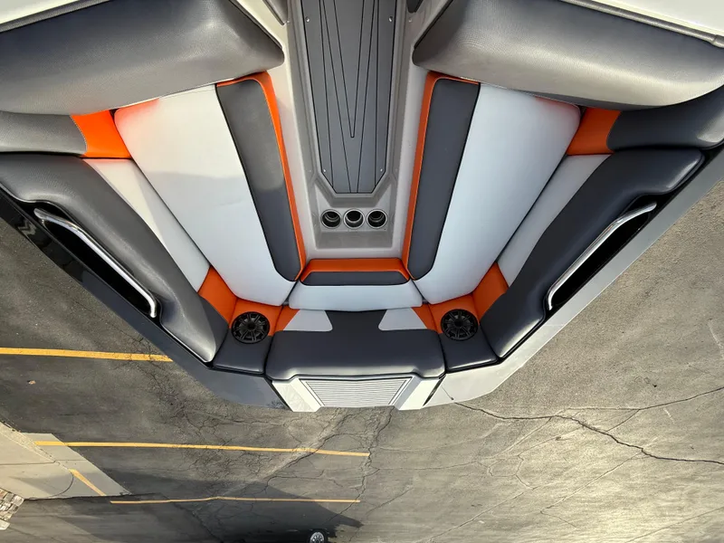 Slide: The Image of 2018 Moomba Helix boat interior with orange, gray, and white seating. - 24