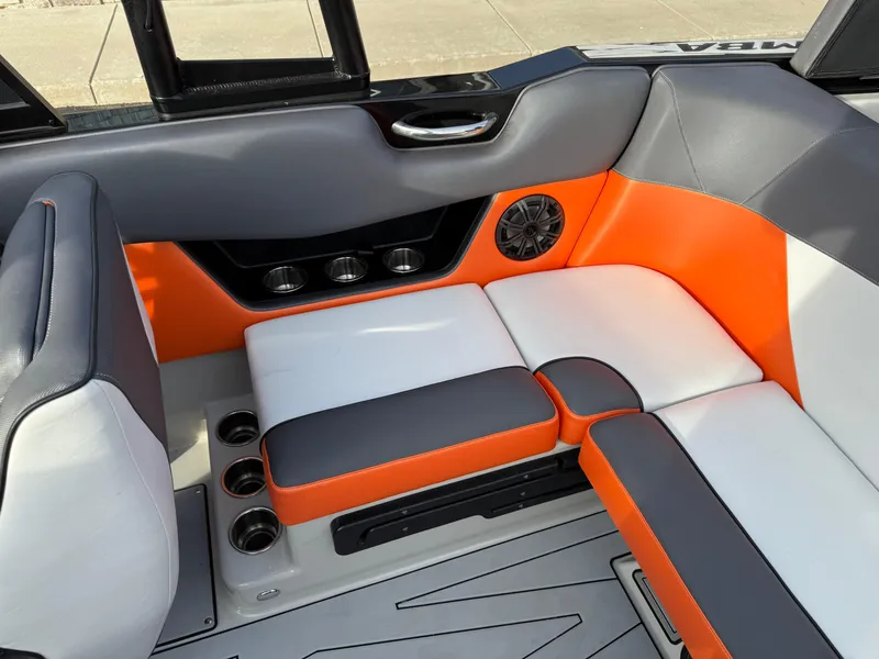Slide: The Image of 2018 Moomba Helix boat interior with orange, gray, and white seating. - 29