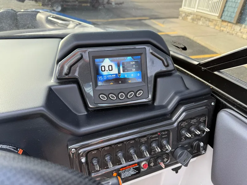 Slide: The Image of 2018 Moomba Helix dashboard with digital display and control switches. - 34