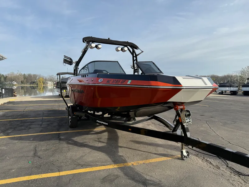 Slide: The Image of 2018 Moomba Helix boat on trailer in parking lot near lake. - 4