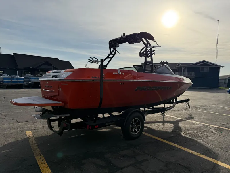 Slide: The Image of 2018 Moomba Helix boat on trailer in parking lot, sun setting in background. - 6