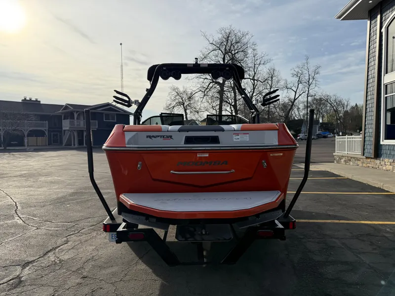 Slide: The Image of 2018 Moomba Helix boat, orange, parked outdoors, rear view with wakeboard tower. - 7