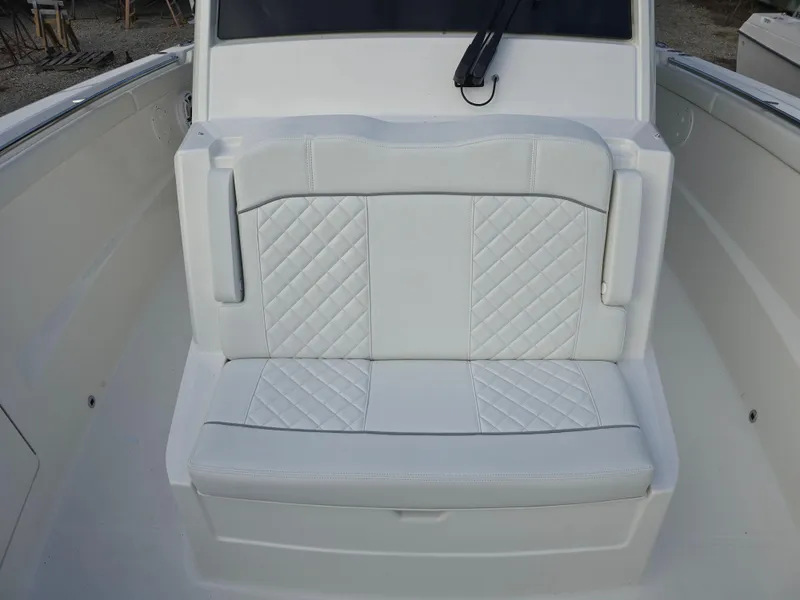 Slide: The Image of 2025 Pursuit S 328 boat seat with white quilted upholstery. - 19