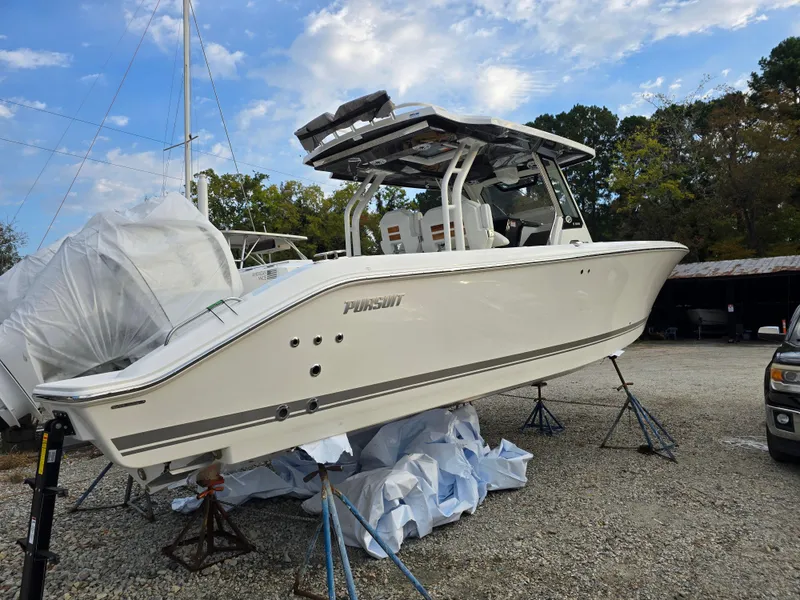 Slide: The Image of 2025 Pursuit S 328 boat on stands, outdoor setting, clear sky background. - 4