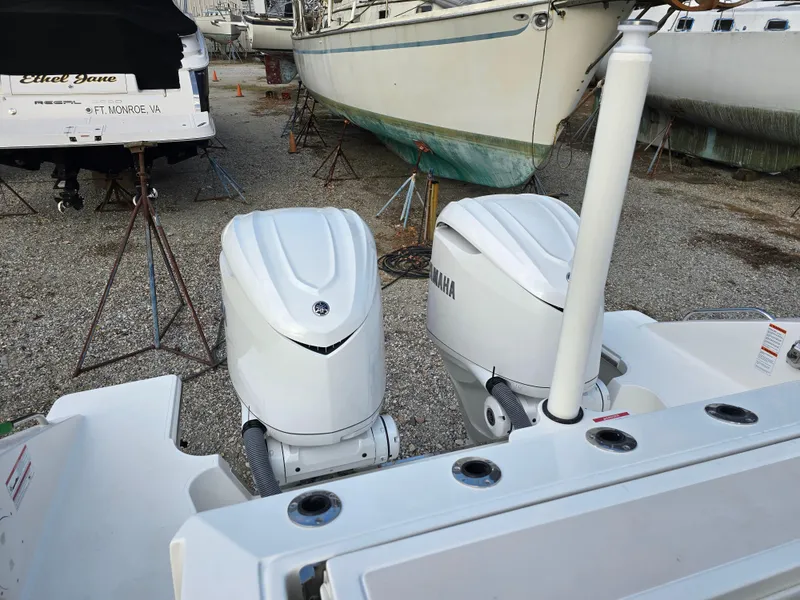 Slide: The Image of 2025 Pursuit S 328 boat with dual outboard engines in a marina. - 5