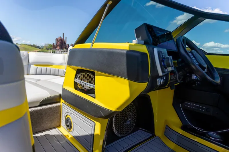 Slide: The Image of Interior of a 2016 Malibu 24.5 MKZ boat with yellow and black accents. - 12