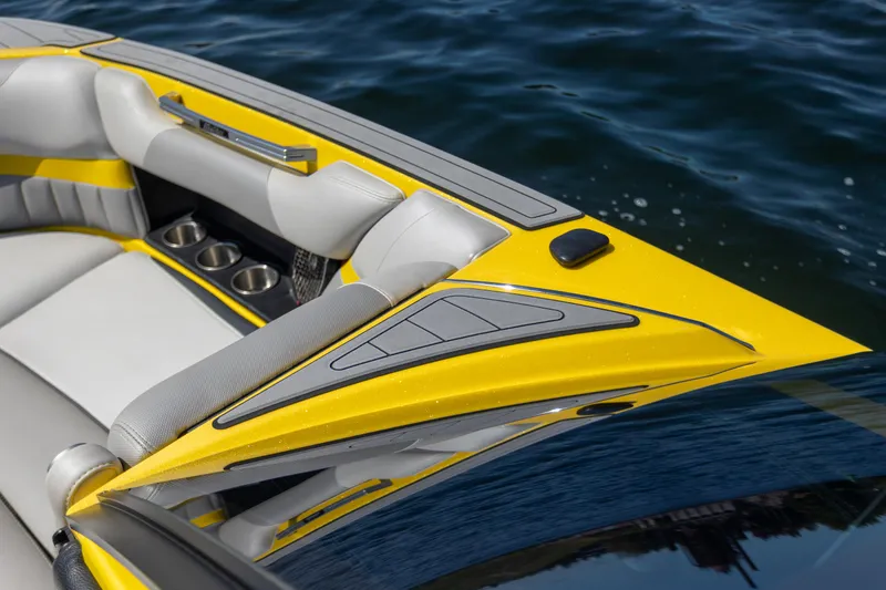 Slide: The Image of 2016 Malibu 24.5 MKZ boat interior with yellow accents on water. - 19