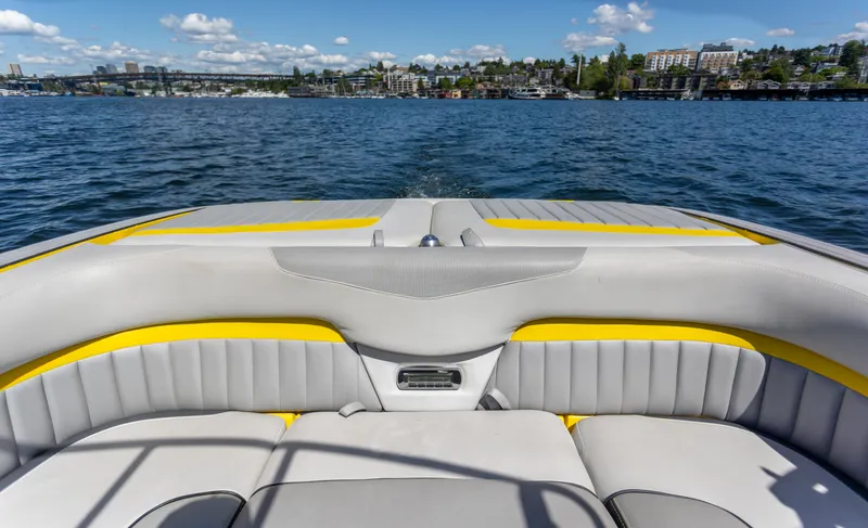 Slide: The Image of 2016 Malibu 24.5 MKZ boat interior with lake view and city skyline. - 23