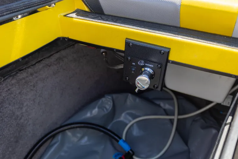 Slide: The Image of Interior view of a 2016 Malibu 24.5 MKZ boat, featuring a control panel and wiring. - 30