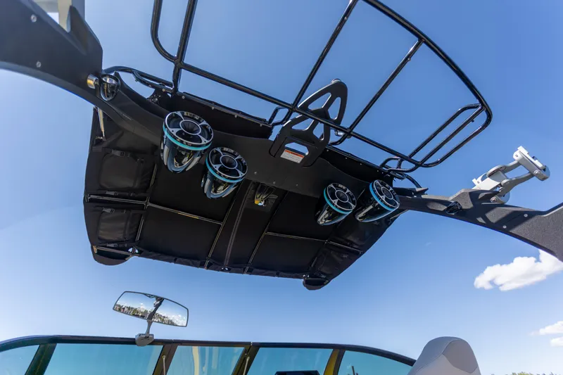 Slide: The Image of 2016 Malibu 24.5 MKZ boat with speakers and wakeboard tower against blue sky. - 33