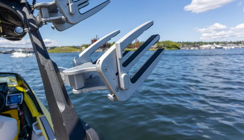 Slide: The Image of Wakeboard rack on a 2016 Malibu 24.5 MKZ boat, with scenic lake view. - 36