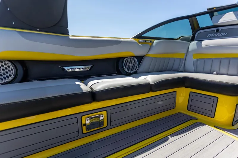 Slide: The Image of Interior of 2016 Malibu 24.5 MKZ boat with yellow and gray seating. - 8