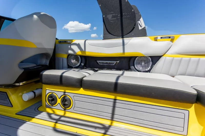 Slide: The Image of 2016 Malibu 24.5 MKZ boat interior with yellow accents and speaker system. - 9