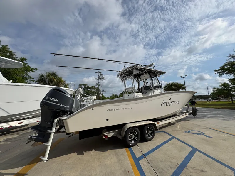 Slide: The Image of 2006 Cape Horn 31 T boat on trailer with Yamaha engine, parked outdoors. - 11