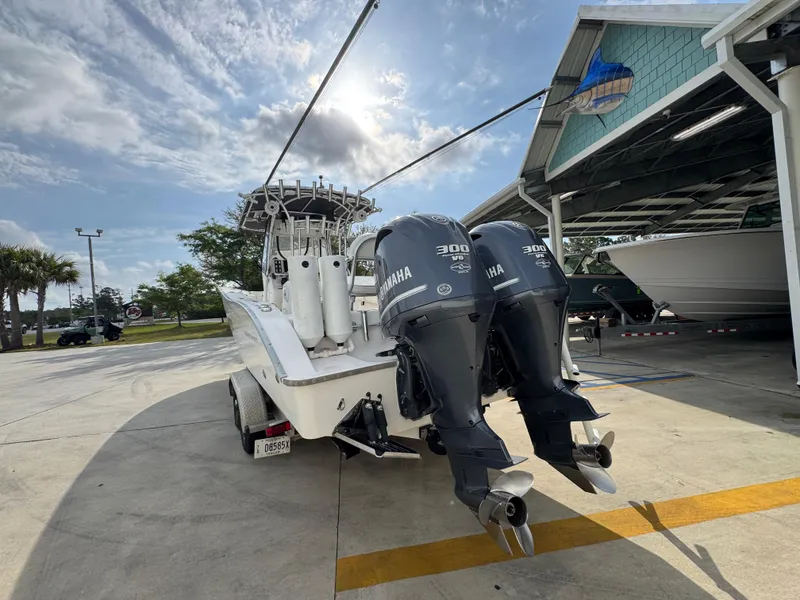 Slide: The Image of 2006 Cape Horn 31 T boat with twin Yamaha 300 engines in a marina setting. - 16