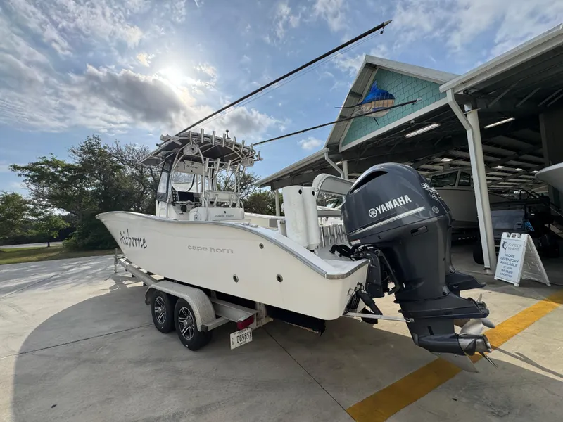 Slide: The Image of 2006 Cape Horn 31 T boat with Yamaha engine on trailer, parked near a building. - 17