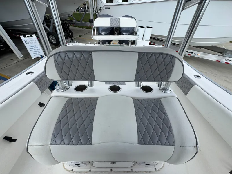 Slide: The Image of 2006 Cape Horn 31 T boat seating with gray and white upholstery, featuring cup holders. - 26