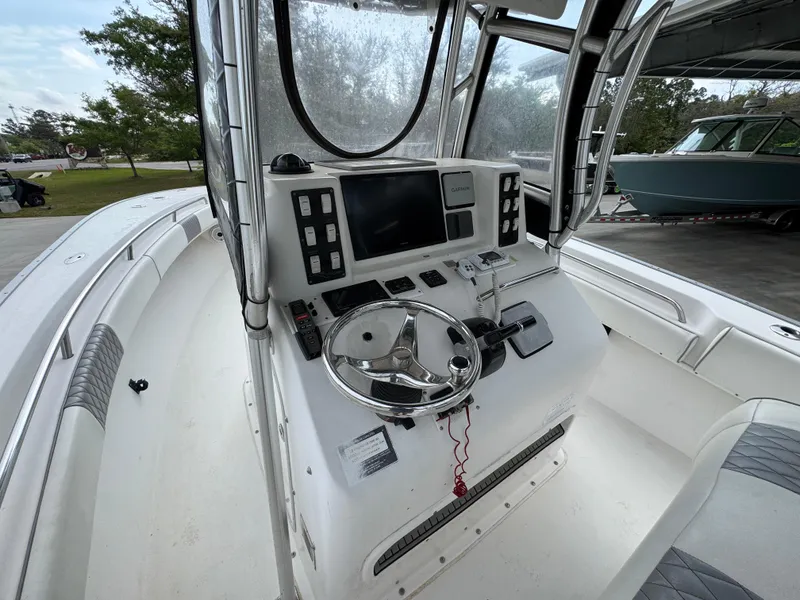 Slide: The Image of 2006 Cape Horn 31 T boat console with steering wheel and navigation controls. - 27