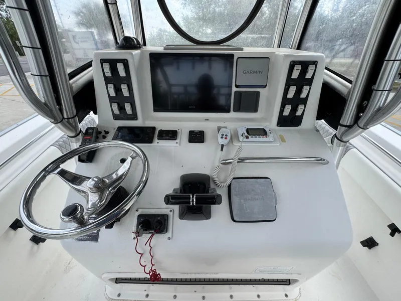 Slide: The Image of 2006 Cape Horn 31 T boat console with steering wheel and Garmin display. - 28