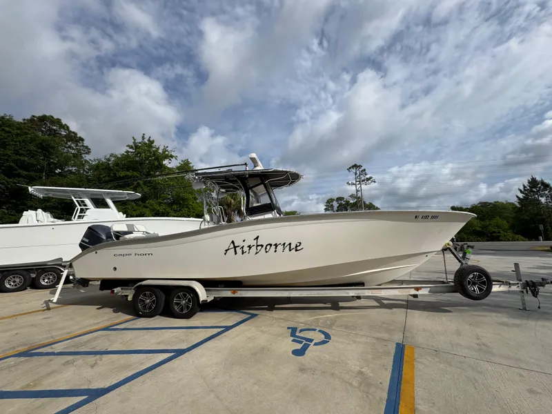 Slide: The Image of 2006 Cape Horn 31 T boat named "Airborne" on a trailer in a parking lot. - 9