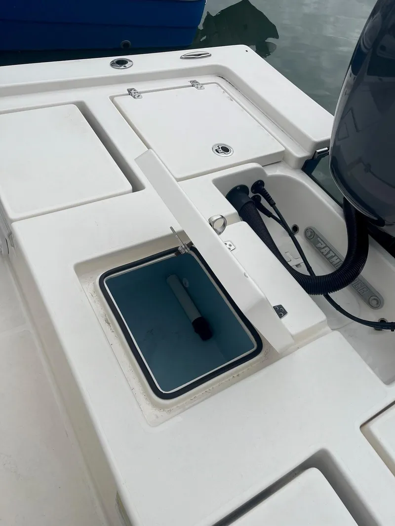 Slide: The Image of 2023 Pathfinder 2200 TRS boat deck with storage compartments and engine cables. - 6