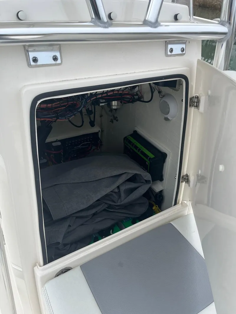 Slide: The Image of 2023 Pathfinder 2200 TRS boat storage compartment with wiring and equipment. - 9
