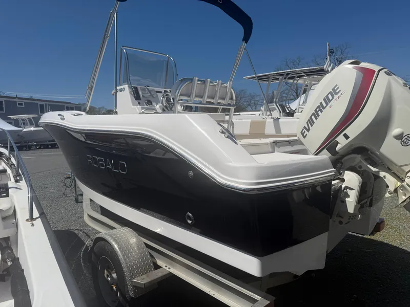Slide: The Image of 2018 Robalo R180 Center Console boat with Evinrude engine on trailer. - 4
