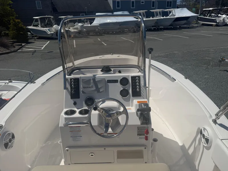 Slide: The Image of 2018 Robalo R180 Center Console boat interior with steering wheel and control panel. - 5