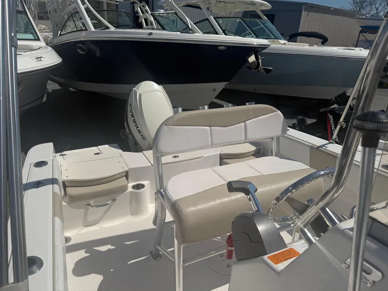 Slide: The Image of 2018 Robalo R180 Center Console boat interior with seating and controls. - 6