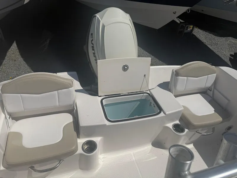 Slide: The Image of 2018 Robalo R180 Center Console boat interior with seating and engine. - 7