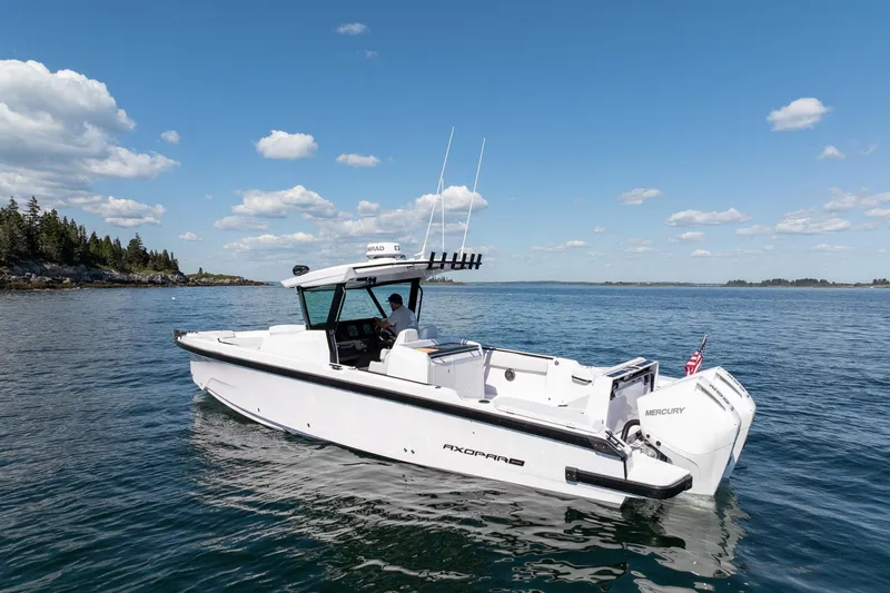 The Image of 2025 Axopar CCX Center Console boat on calm ocean waters under clear blue sky. - 0