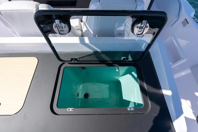 Slide: The Image of 2025 Axopar CCX Center Console boat with sleek sink and faucet, scenic water view. - 12