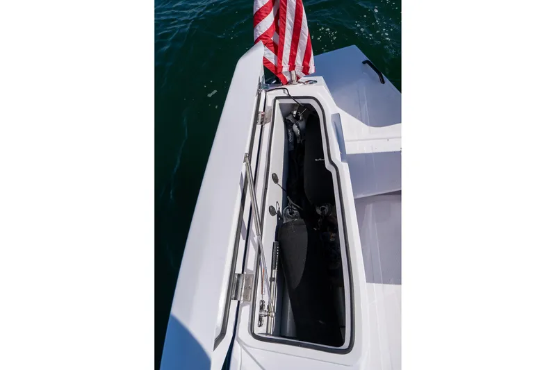 Slide: The Image of 2025 Axopar CCX Center Console boat with American flag on open water. - 17