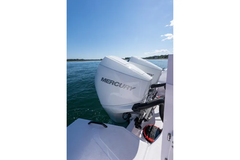 Slide: The Image of 2025 Axopar CCX Center Console boat with open storage compartment and American flag. - 18