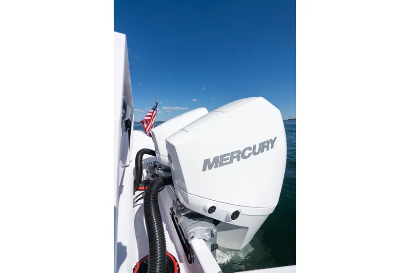 Slide: The Image of 2025 Axopar CCX Center Console with Mercury outboard engines on water. - 19