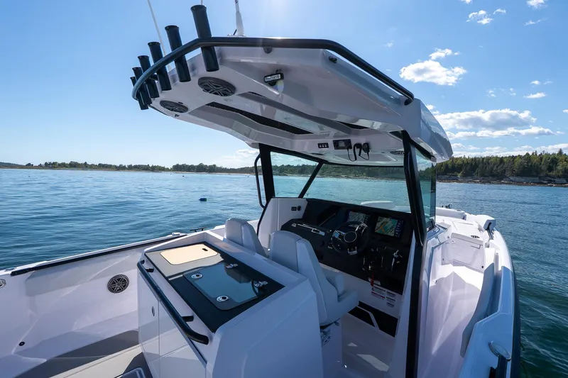Slide: The Image of 2025 Axopar CCX Center Console with Mercury outboard engine on open water. - 20