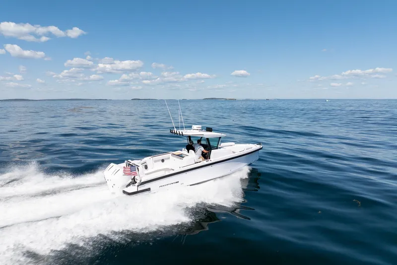 Slide: The Image of 2025 Axopar CCX Center Console boat cruising on a clear, sunny day. - 3