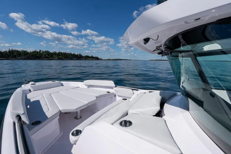 Slide: The Image of 2025 Axopar CCX Center Console boat cruising on a sunny day. - 32