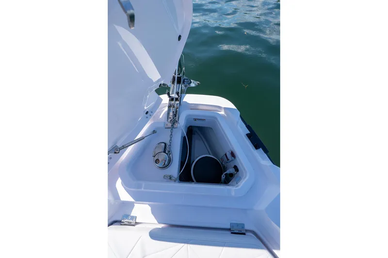 Slide: The Image of 2025 Axopar CCX Center Console boat on calm water with scenic island view. - 35