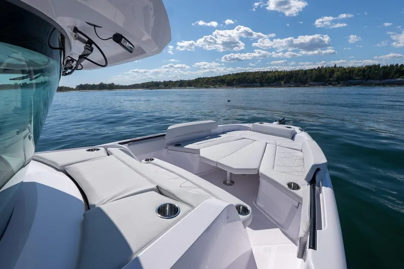 Slide: The Image of 2025 Axopar CCX Center Console anchor compartment with open hatch, showing anchor chain and storage. - 36