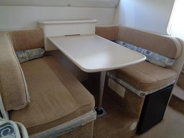Slide: The Image of 2002 Bayliner 2855 Ciera interior with beige seating and dining table. - 16