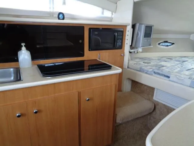 Slide: The Image of Interior of 2002 Bayliner 2855 Ciera boat with kitchenette and sleeping area. - 19