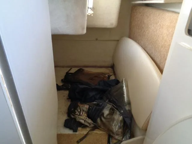 Slide: The Image of 2002 Bayliner 2855 Ciera cabin interior with scattered belongings. - 21