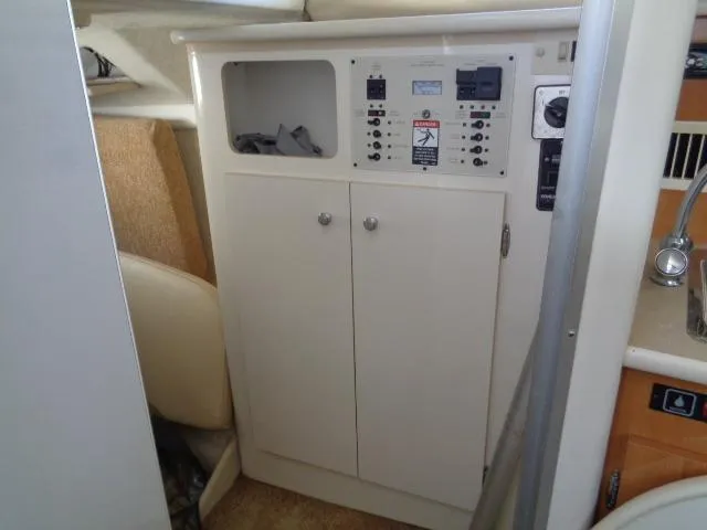 Slide: The Image of 2002 Bayliner 2855 Ciera interior control panel and storage cabinet. - 22