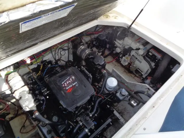 Slide: The Image of Engine compartment of 2002 Bayliner 2855 Ciera boat, showcasing mechanical components and wiring. - 27