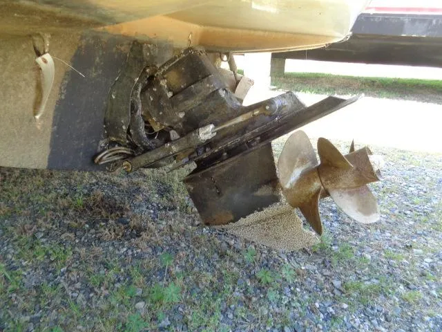 Slide: The Image of 2002 Bayliner 2855 Ciera boat propeller and stern drive on gravel surface. - 29