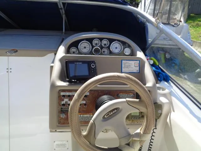 Slide: The Image of 2002 Bayliner 2855 Ciera boat dashboard with steering wheel and navigation instruments. - 5