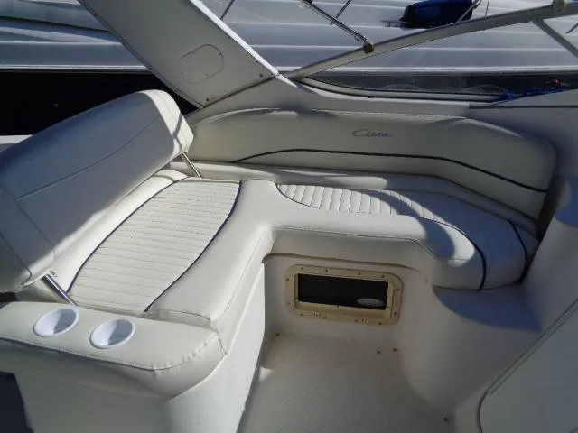 Slide: The Image of 2002 Bayliner 2855 Ciera boat interior with white cushioned seating and cup holders. - 8