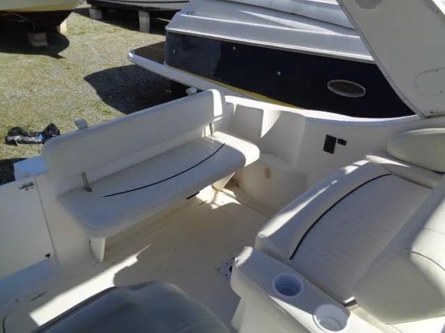 Slide: The Image of 2002 Bayliner 2855 Ciera boat interior with white seating and cup holders. - 9