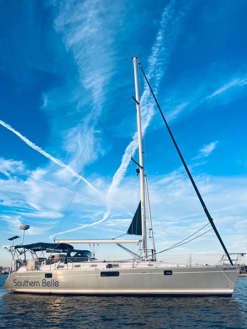 Slide: The Image of 1994 Beneteau Oceanis 440 sailboat on water under clear blue sky. - 0